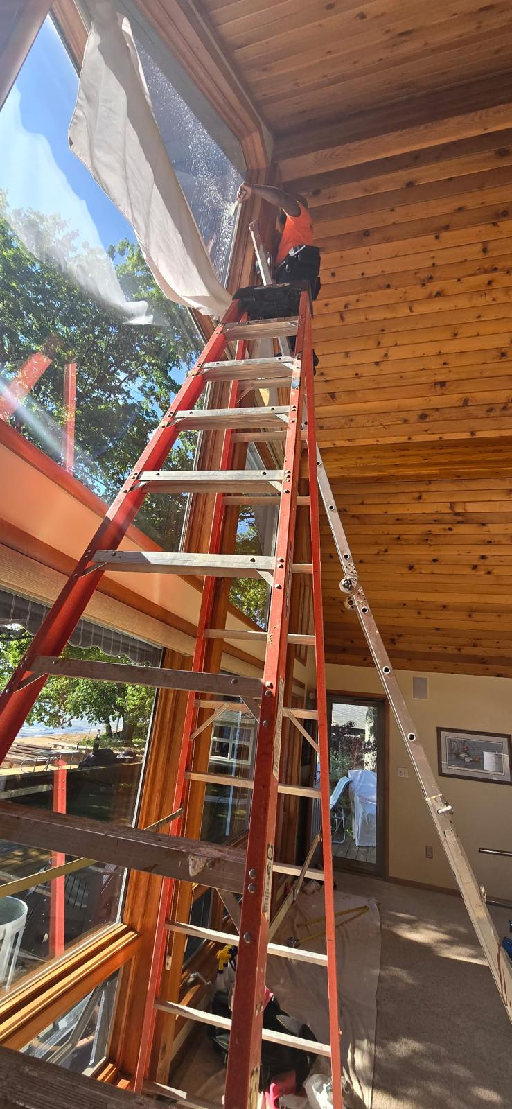 DRE installing architectural window film on a vaulted lakefront atrium